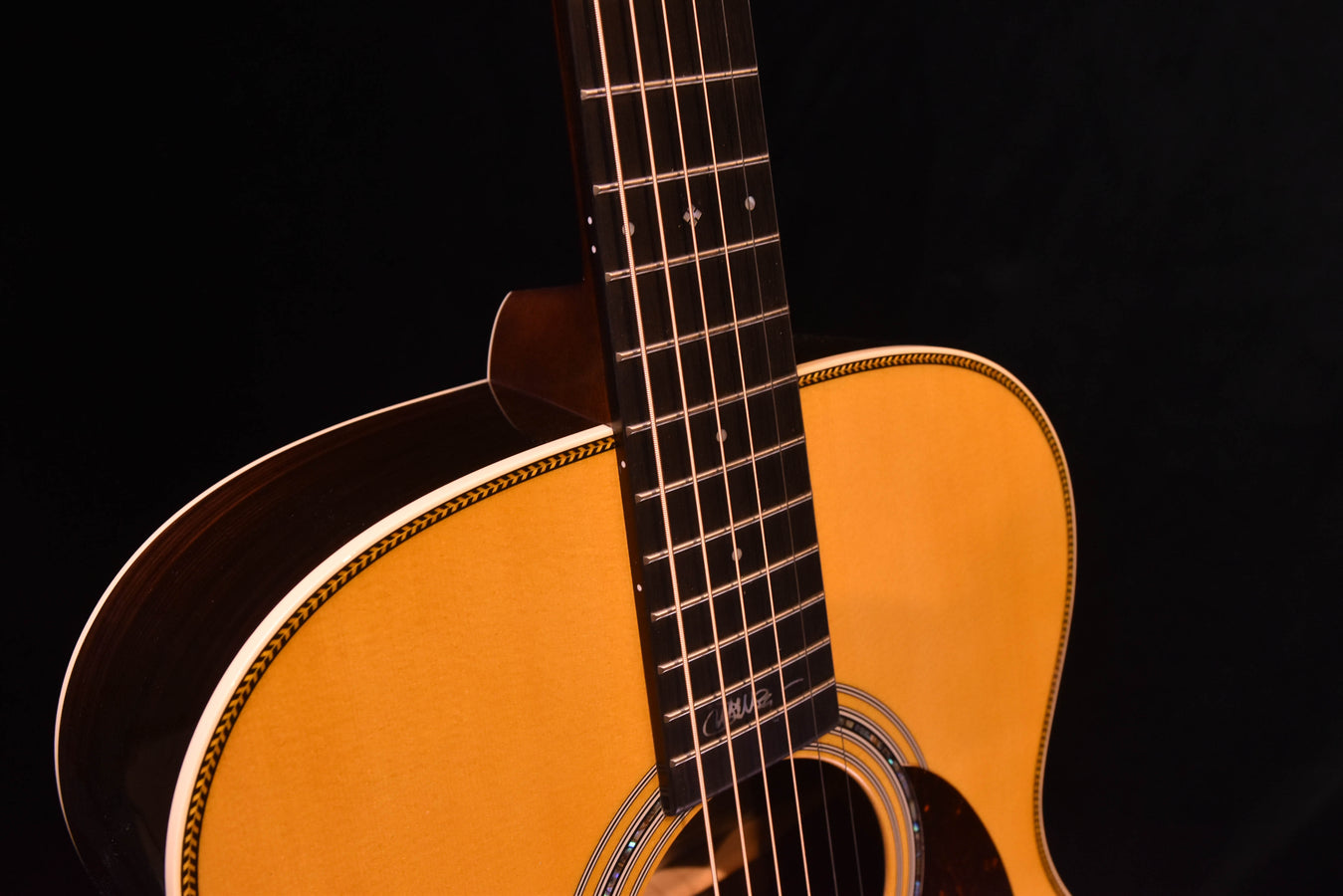 Acoustic-electric guitar neck and upper body with decorative binding around soundhole