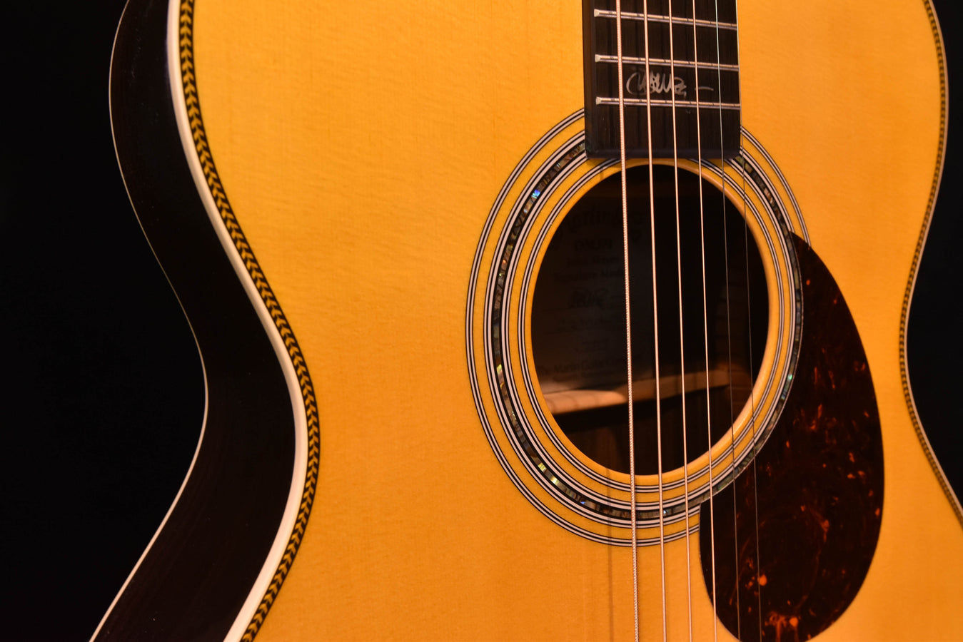 Acoustic-electric guitar soundhole with multi-ring rosette and glossy pickguard