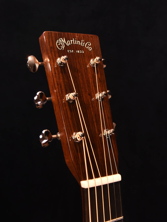 Acoustic-electric guitar neck and headstock close-up with Martin tuning hardware