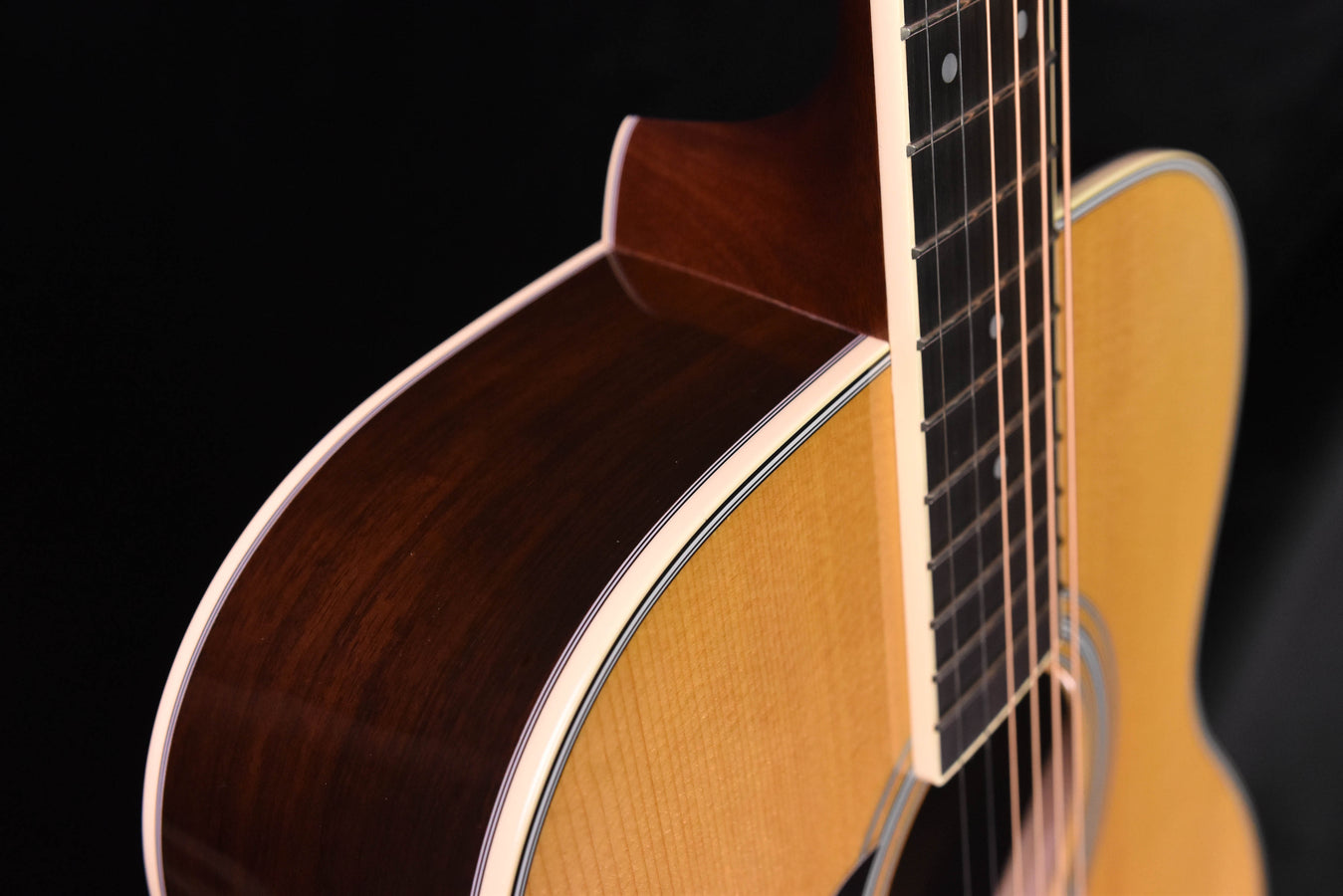Acoustic guitar neck and headstock area, frets and strings visible