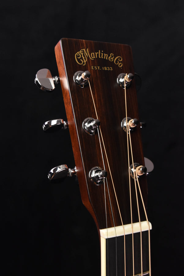 Martin acoustic guitar headstock with chrome tuners and logo