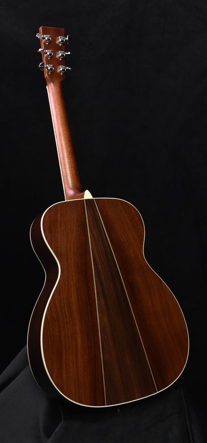 Left-handed acoustic guitar full-body side view with tuning pegs