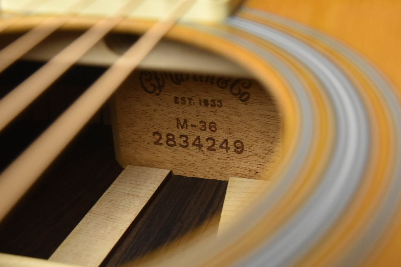 Acoustic guitar M-36 label on soundboard, near sound hole rosette