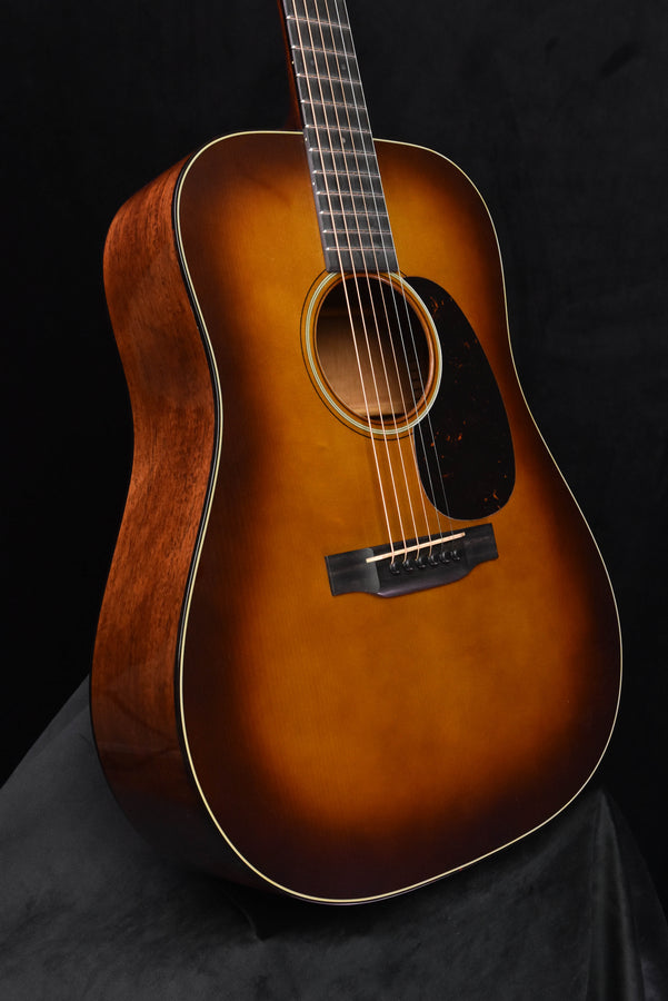 Amber burst acoustic guitar, full front view showing pickguard and bridge area