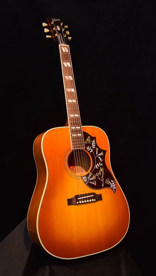 Cherry sunburst acoustic guitar, full front view with headstock and tuning pegs