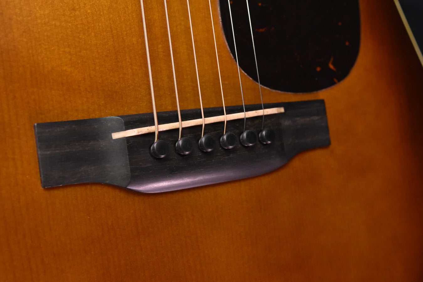 Amber burst acoustic guitar bridge and pickguard with black bridge pins