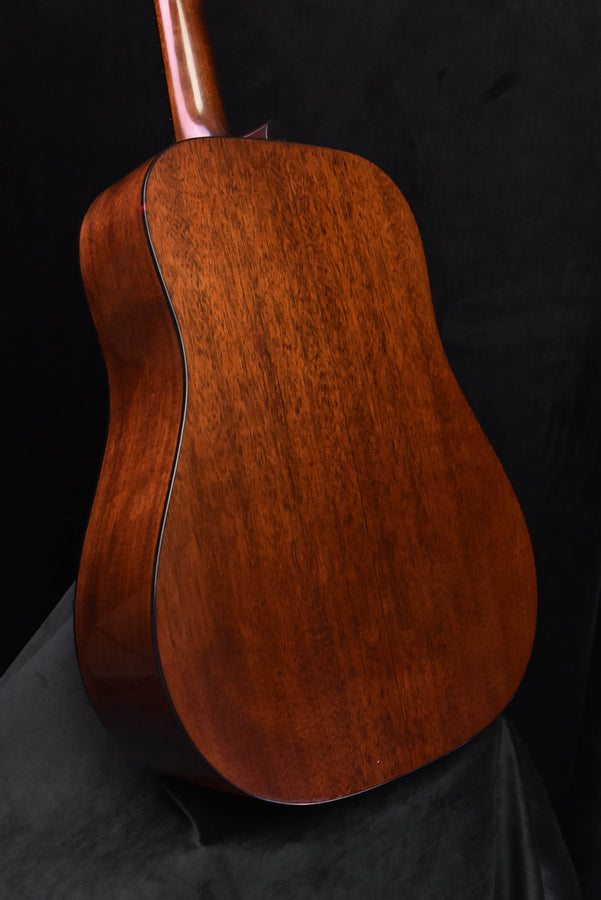 Amber burst acoustic guitar back view with visible wood grain