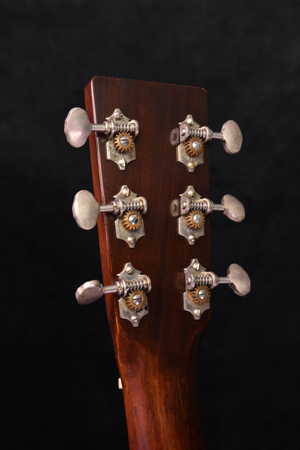 Headstock close-up with six tuning machines, amber burst guitar