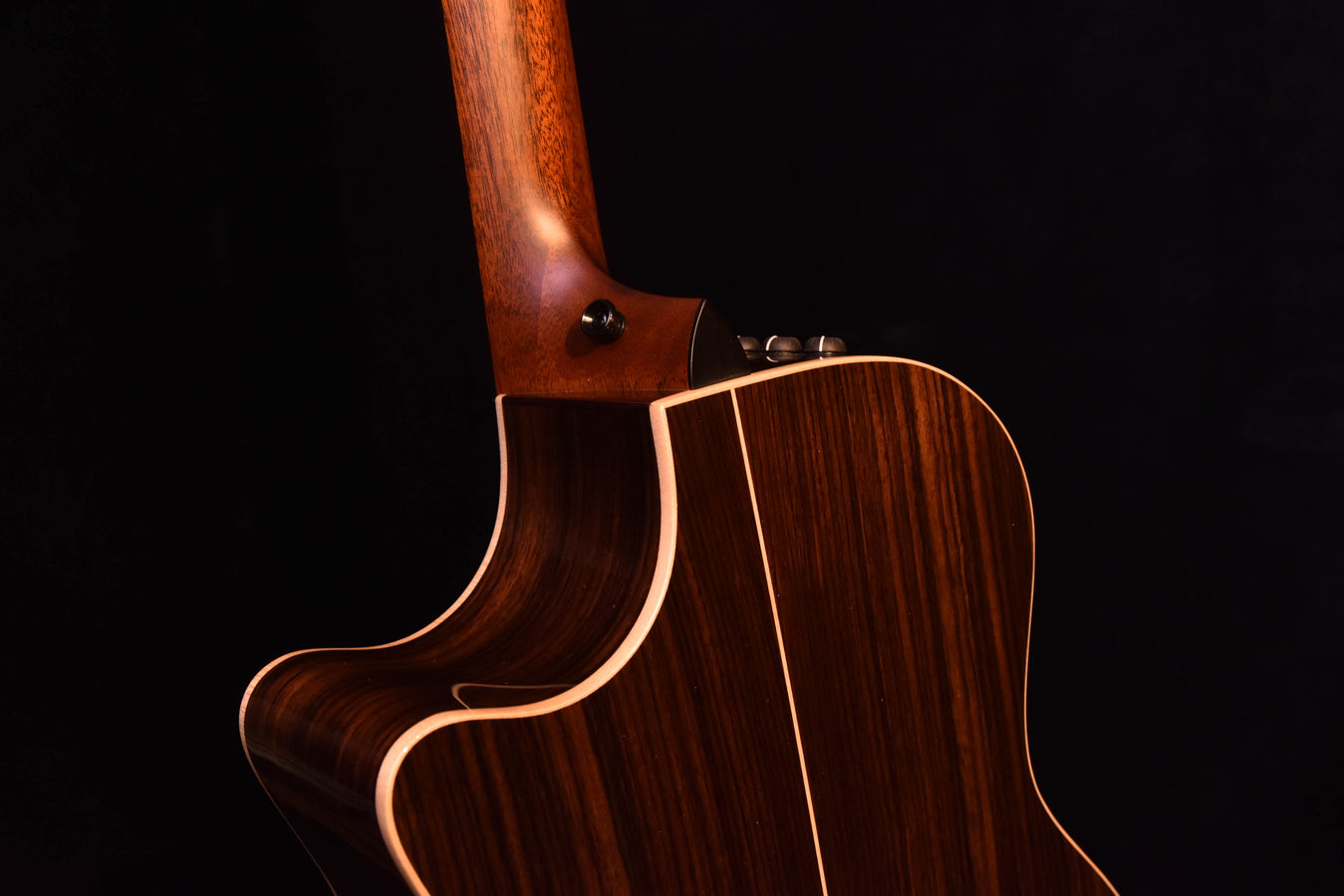 Taylor acoustic guitar body with dark finish and soundhole, angled view