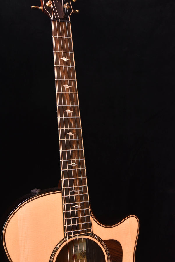 Full view of acoustic-electric guitar neck and light wood body with soundhole