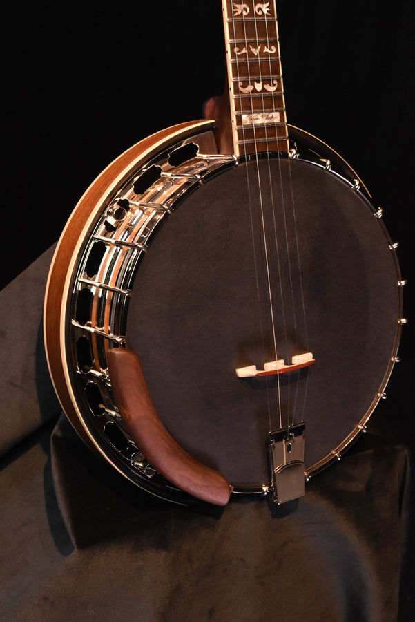 Banjo side view with dark head and chrome tension hardware, wooden rim and armrest