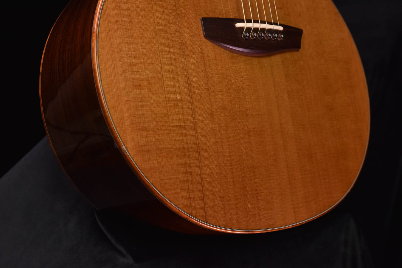 Used McPherson acoustic guitar, lower bout and bridge close-up with strings