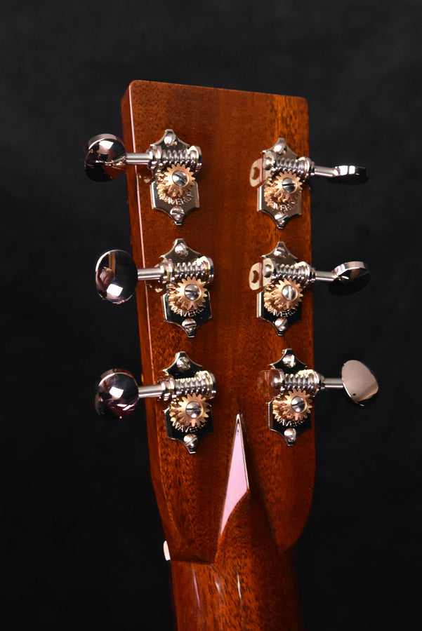 Acoustic guitar headstock tuning keys, ornate tuners, and wooden faceplate