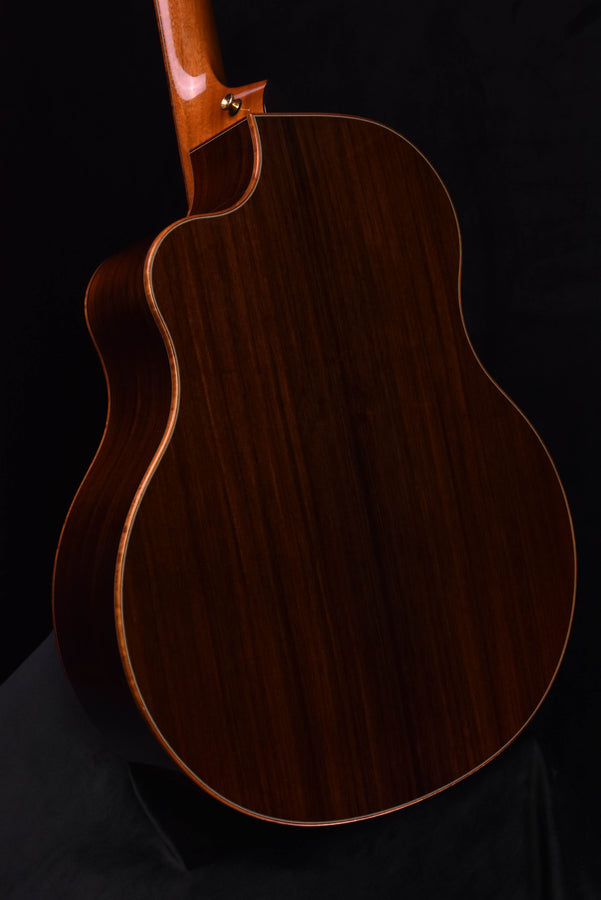 Acoustic guitar body in dark wood with cream binding along the edge