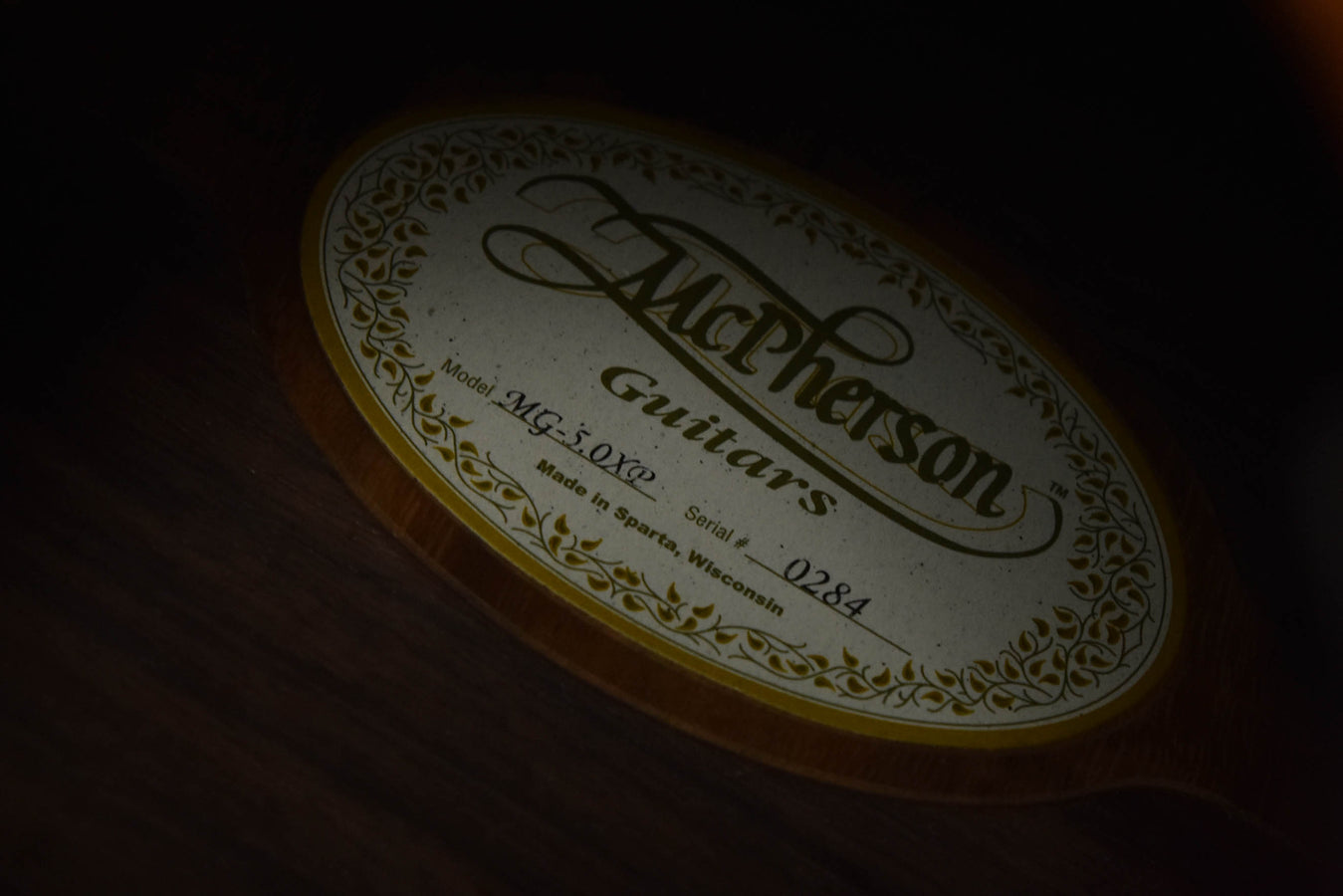 McPherson Guitars oval label with model name and serial number on the soundboard