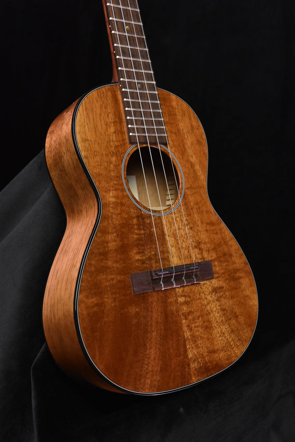 Tenor koa ukulele front view with black binding and round sound hole