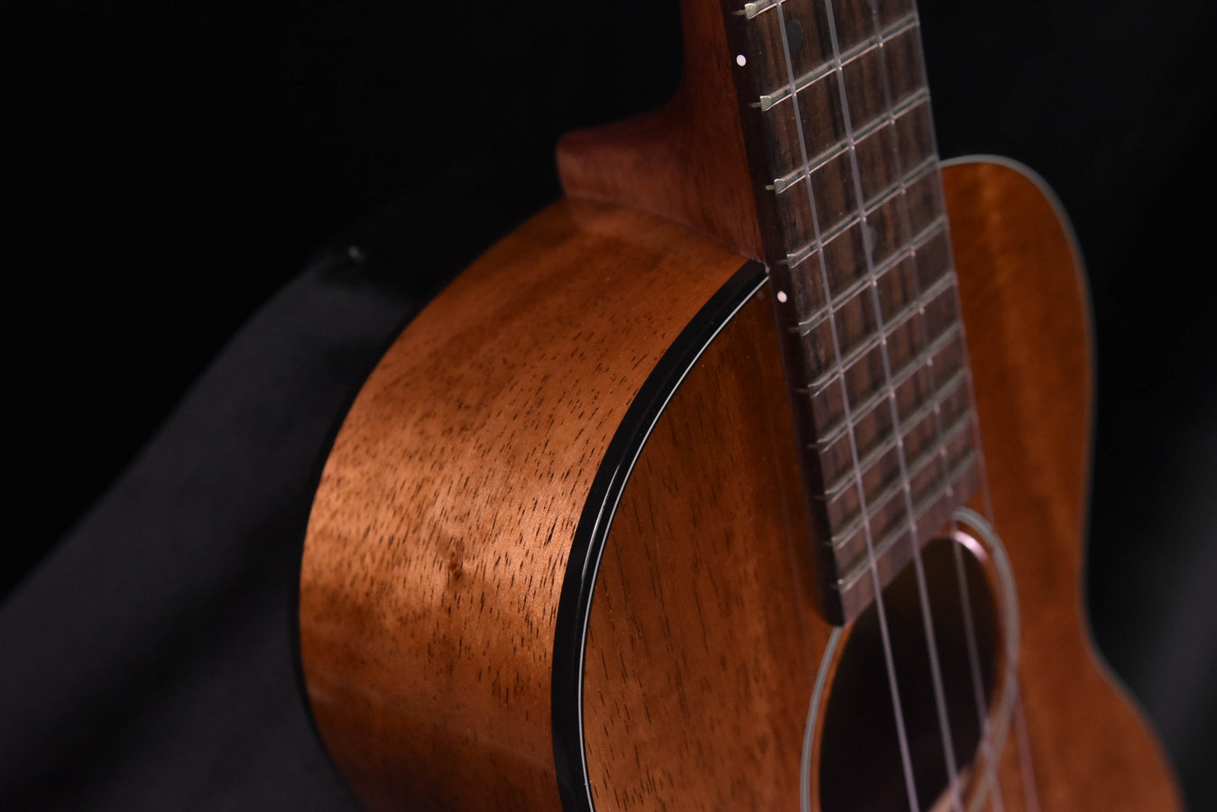 Close-up of koa body edge and neck joint with fretboard