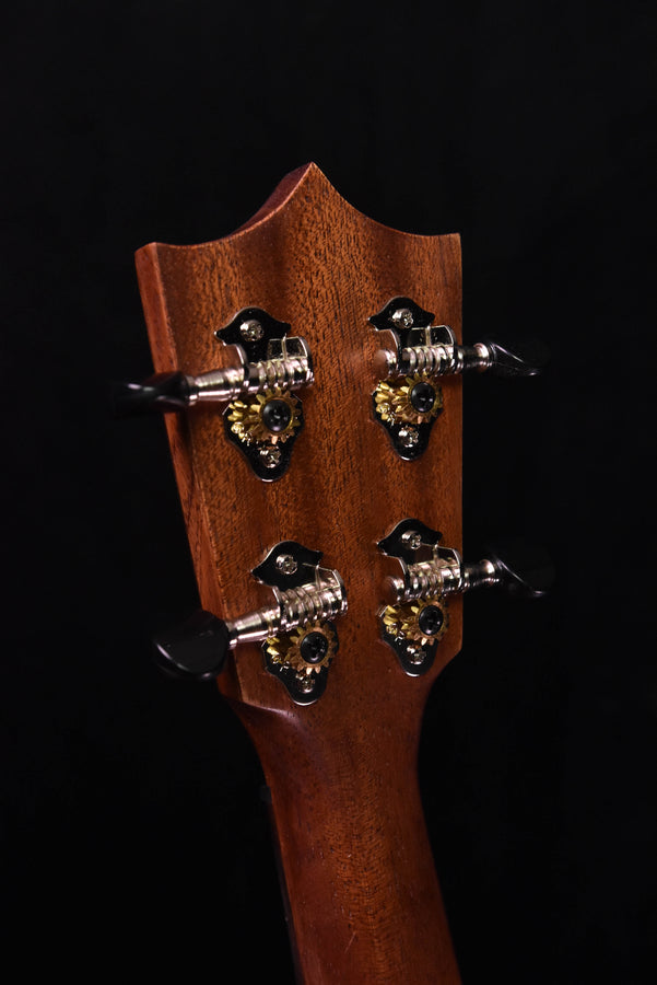 Koa ukulele headstock with four ornate tuning pegs