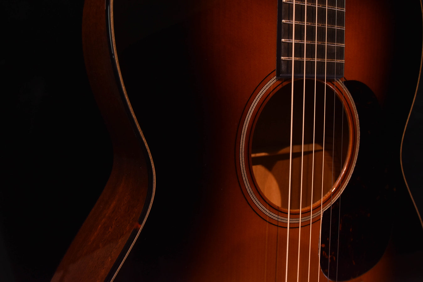 Guitar soundhole with rosette and part of pickguard, close-up front