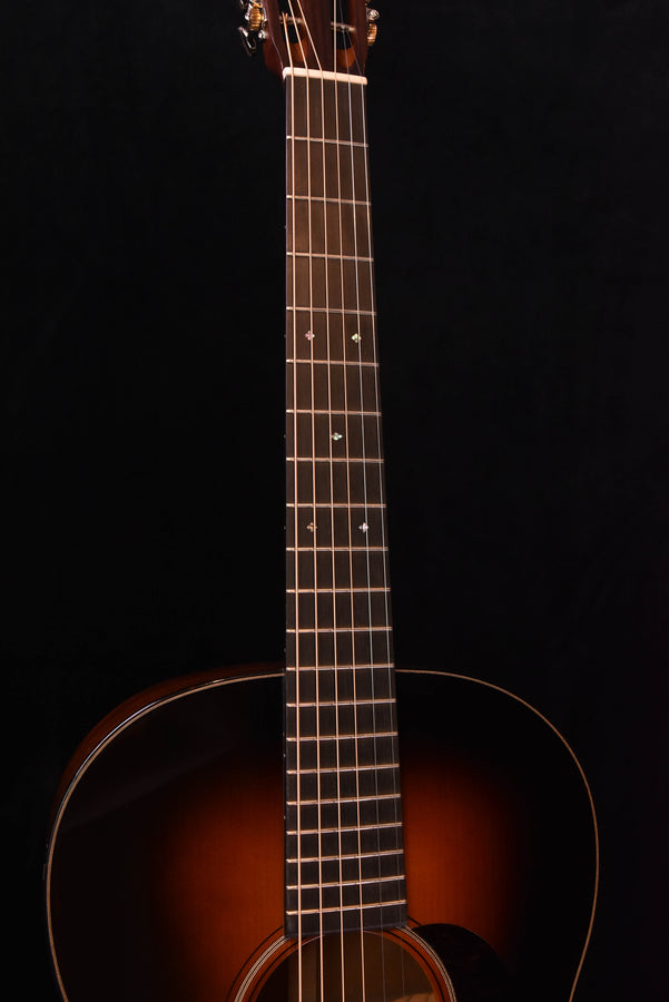 Guitar fretboard view with dot inlays and 12-fret area, warm wood tone