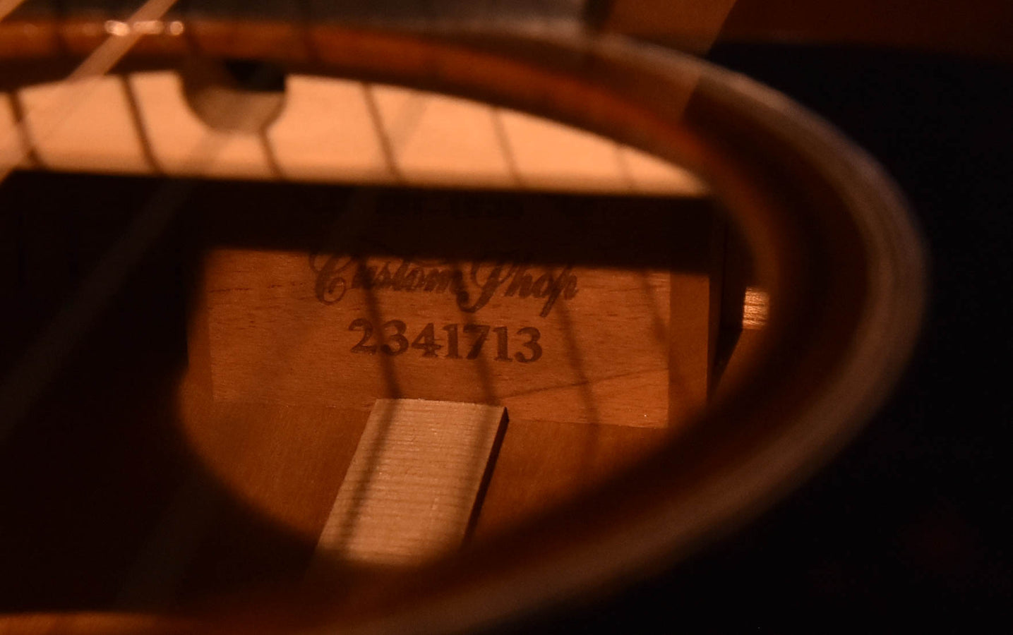 Inside label on guitar body with handwritten text and serial-like number