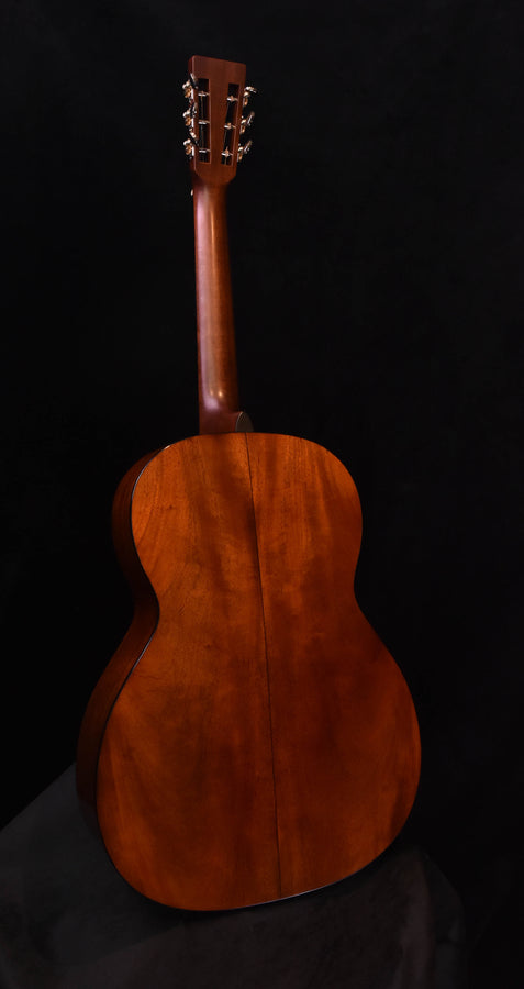 Back view of acoustic guitar in warm mahogany-brown, teardrop shape