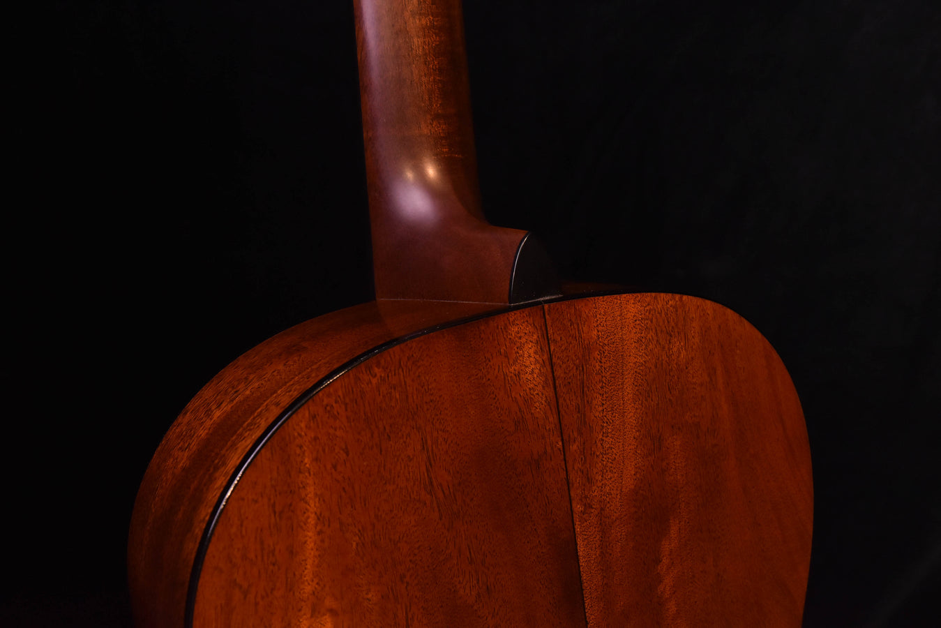 Used mahogany guitar neck-to-body joint with visible seam line and wood grain