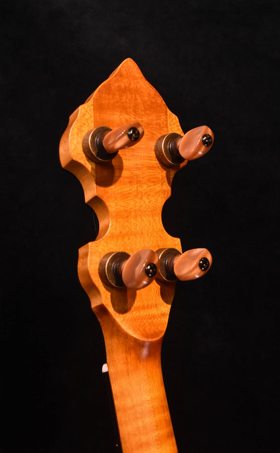Ome five-string banjo headstock with maple wood and four tuning pegs