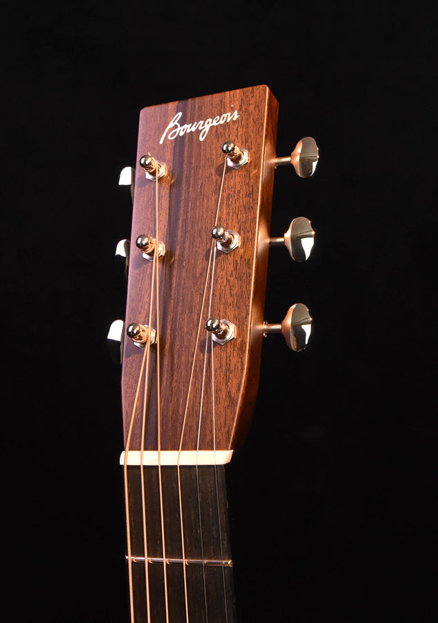 Acoustic guitar headstock with Bourgeois script and six tuning pegs