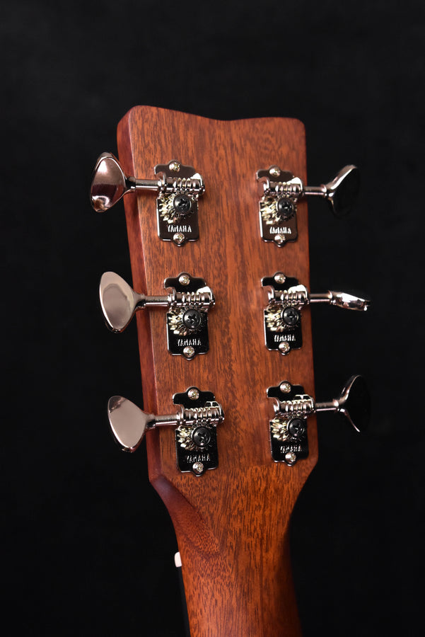 Guitar headstock back with six tuning keys and wood finish on acoustic-electric model