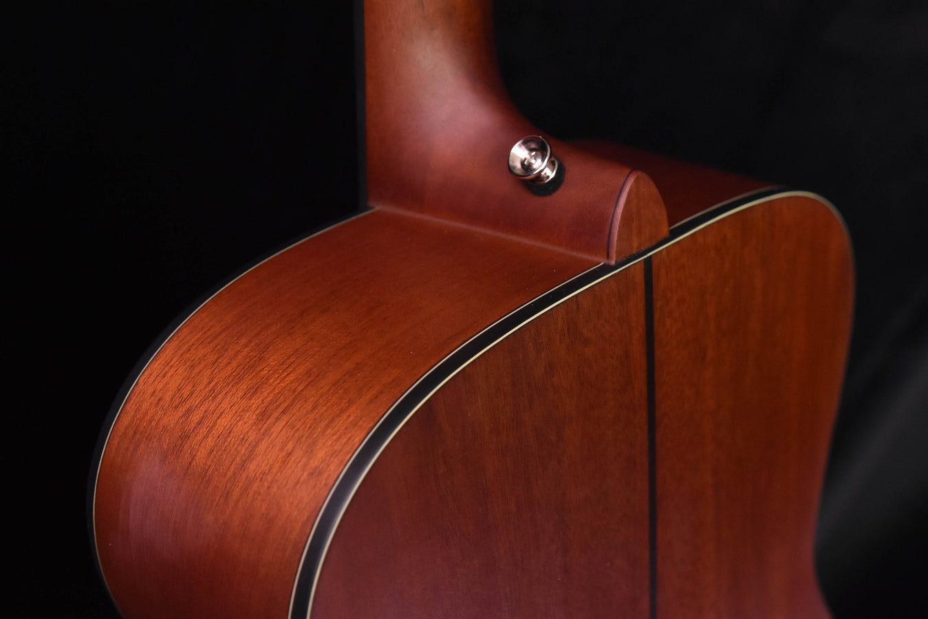 Acoustic-electric guitar top and neck joint with dark soundhole binding