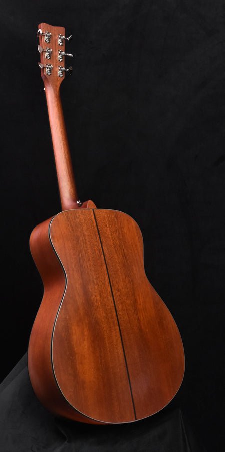 Acoustic-electric guitar back view, neck and headstock in frame with natural wood finish