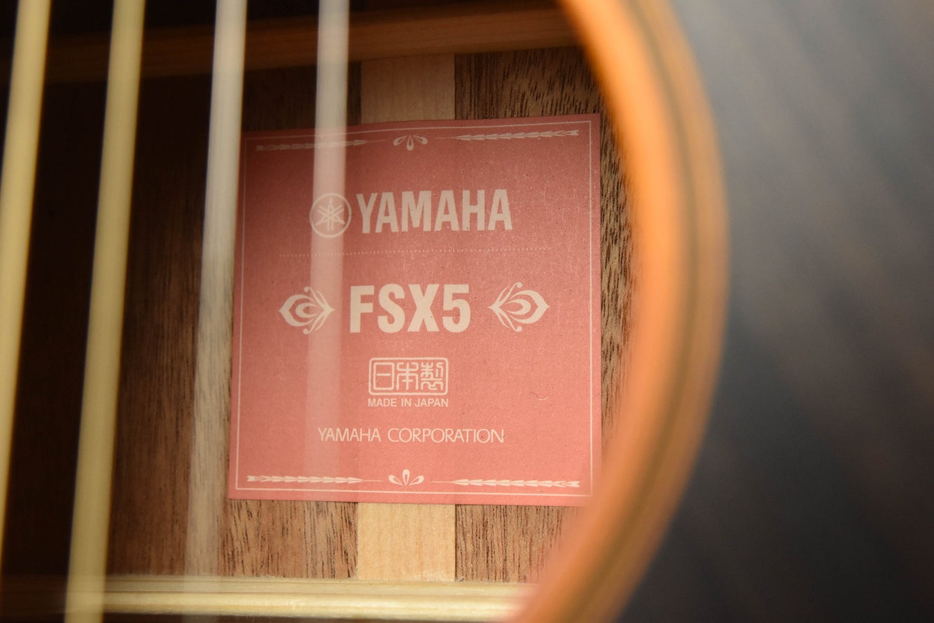 Yamaha FSX5 guitar label on interior wood surface