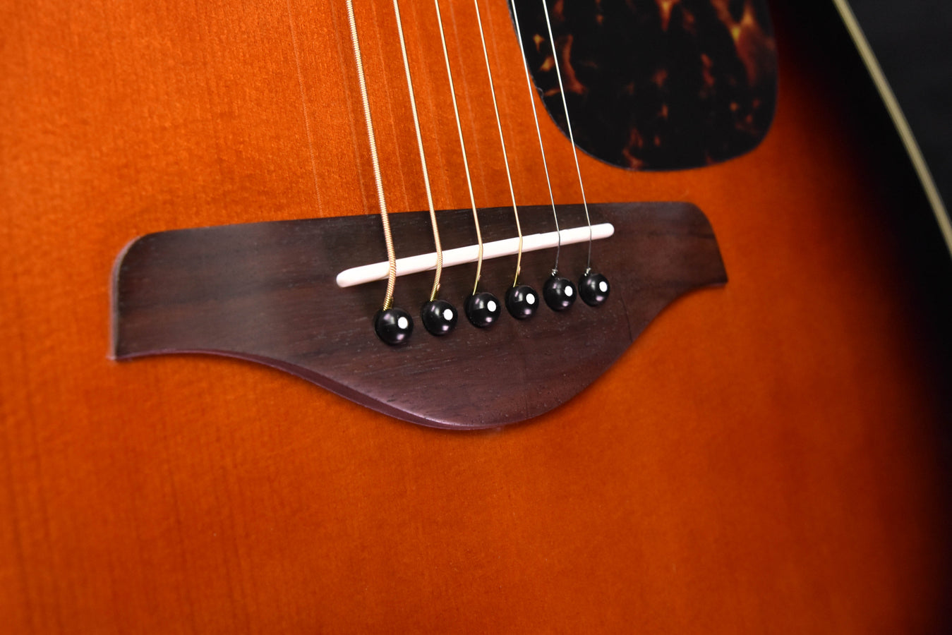 Sunburst acoustic guitar bridge with 6-pin bridge and black saddle