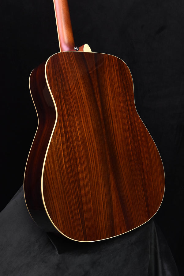 Sunburst acoustic guitar back with white binding and curved body outline