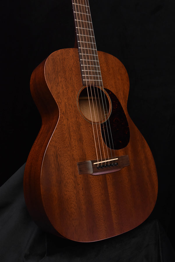 Used acoustic guitar, angled front view with soundhole and bridge visible