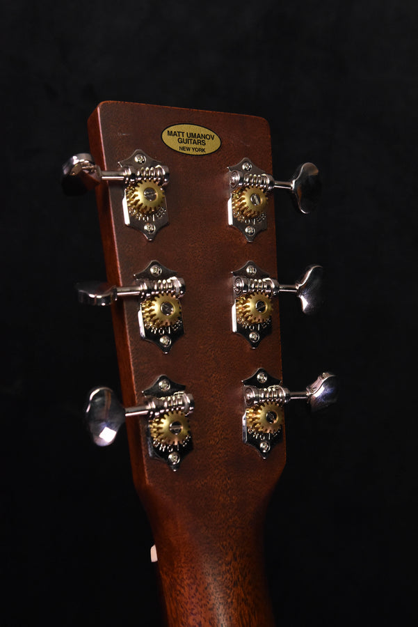 Used acoustic guitar headstock back view with tuning machines and label