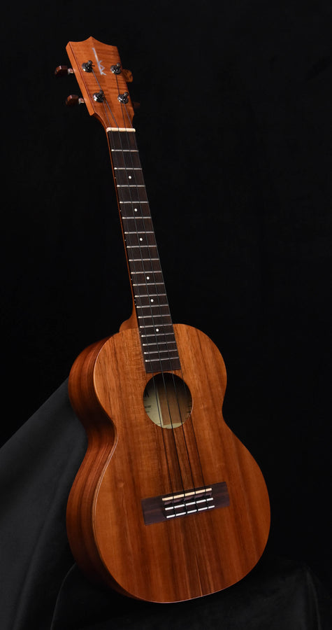 Tenor ukulele, natural brown wood finish, tuning pegs on headstock