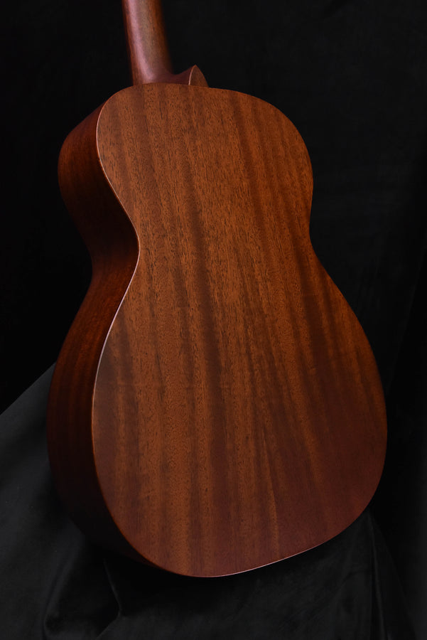 Used acoustic guitar back view of body with curved shape and wood grain