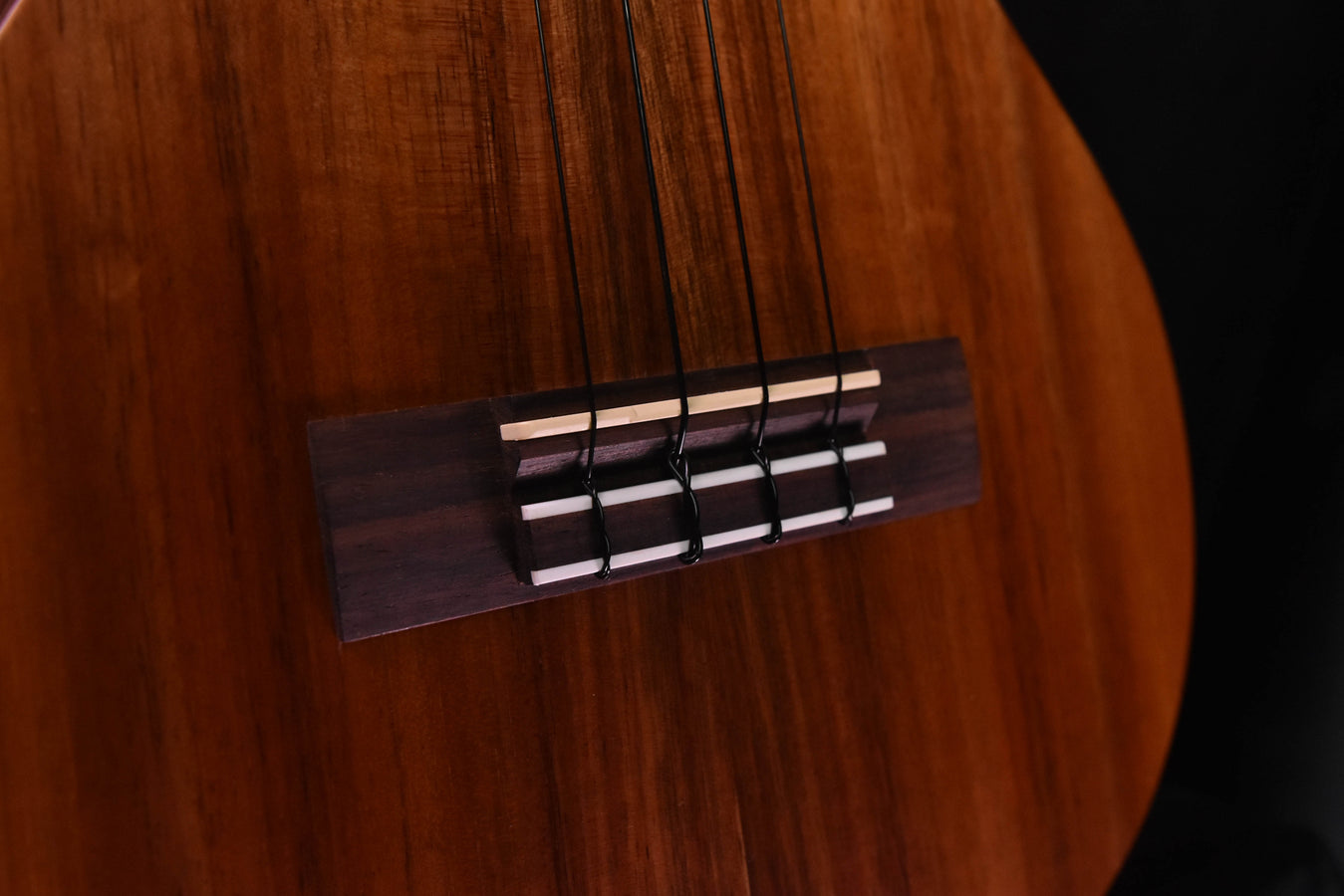 Tenor ukulele bridge and strings, polished wood with metal saddle
