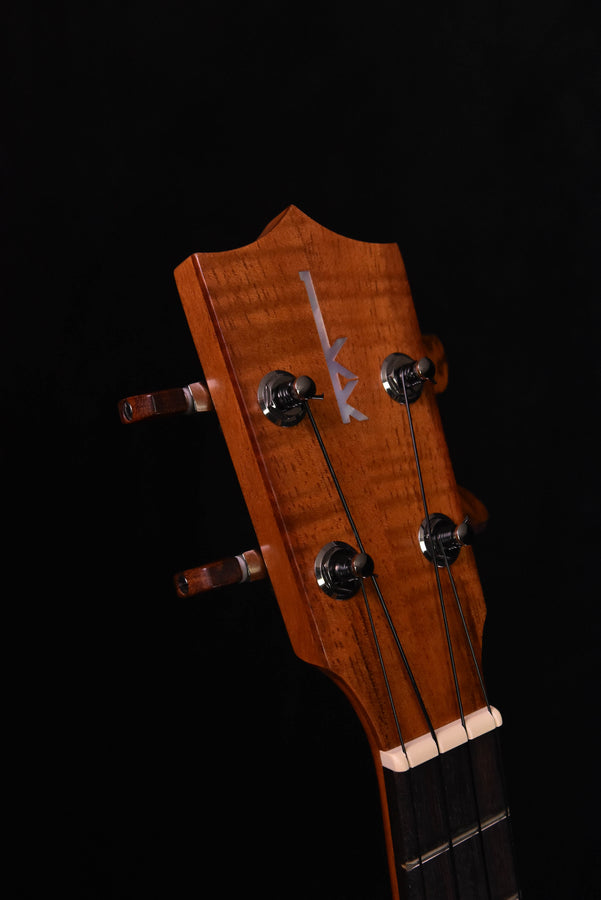 Tenor ukulele headstock with 4 chrome tuners and nut, light brown wood