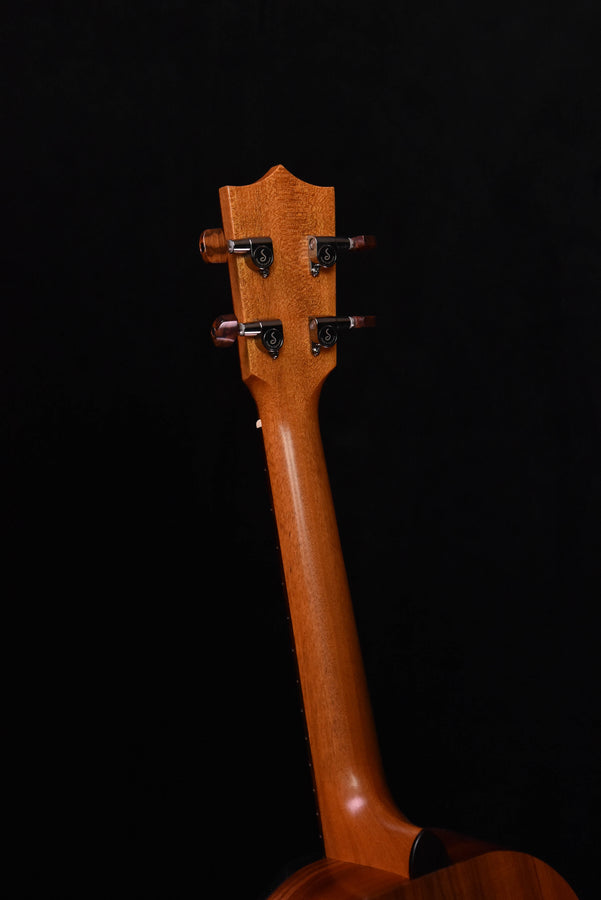 Tenor ukulele neck and headstock from side, chrome tuners on wood
