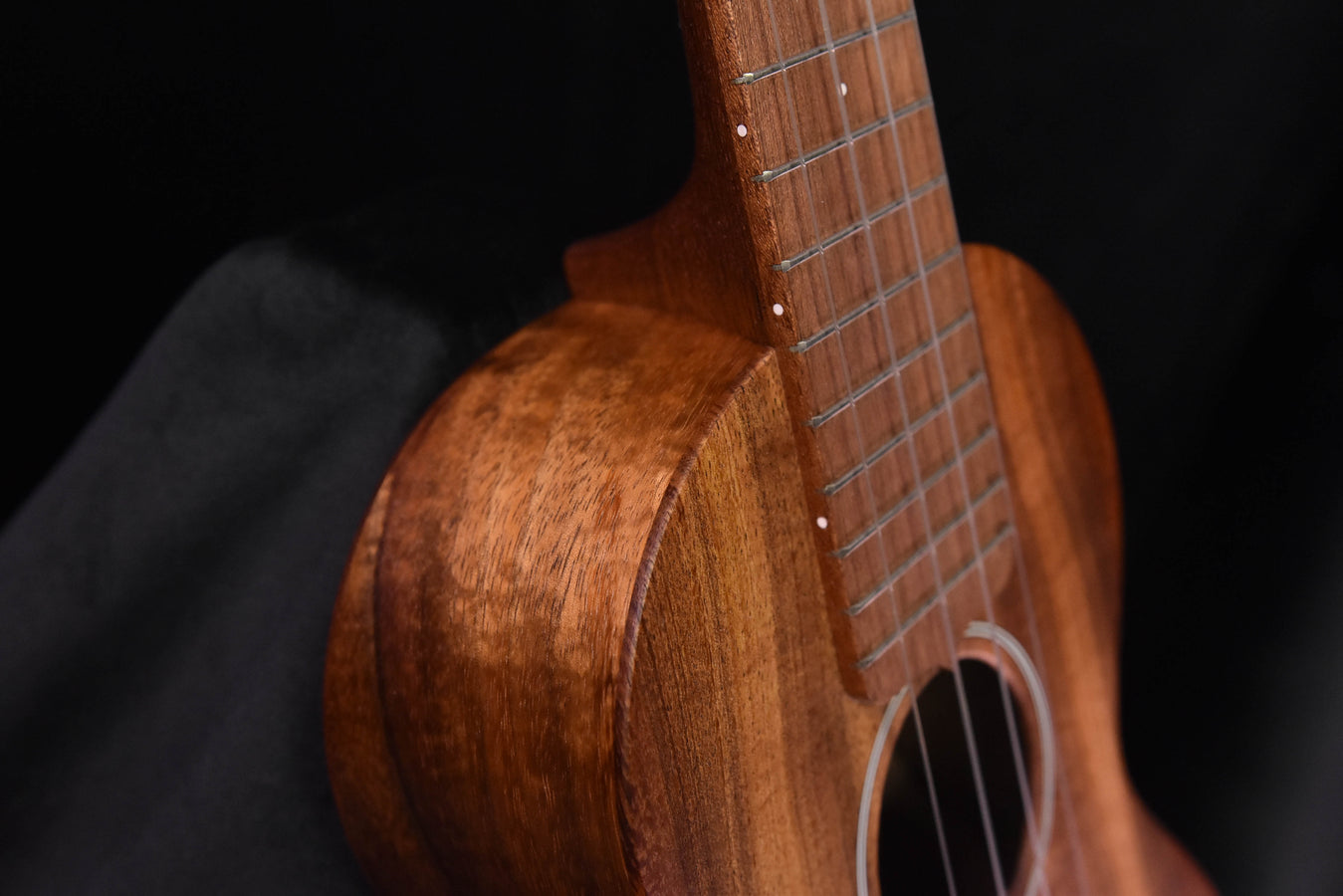 All-Koa concert ukulele, close-up of upper bout and fretboard