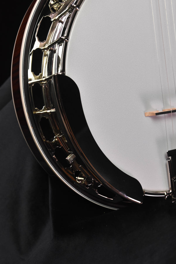 Banjo rim and neck joint with chrome hardware next to the white drumhead