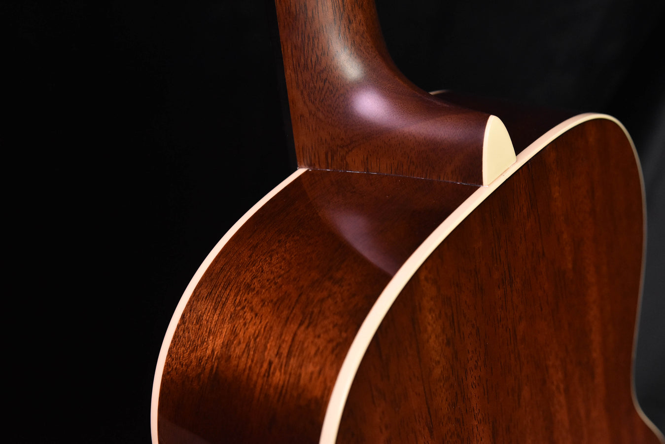 Acoustic guitar body side with glossy brown finish and cream binding