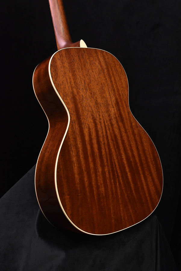 Acoustic guitar body back with warm brown wood grain and cream binding