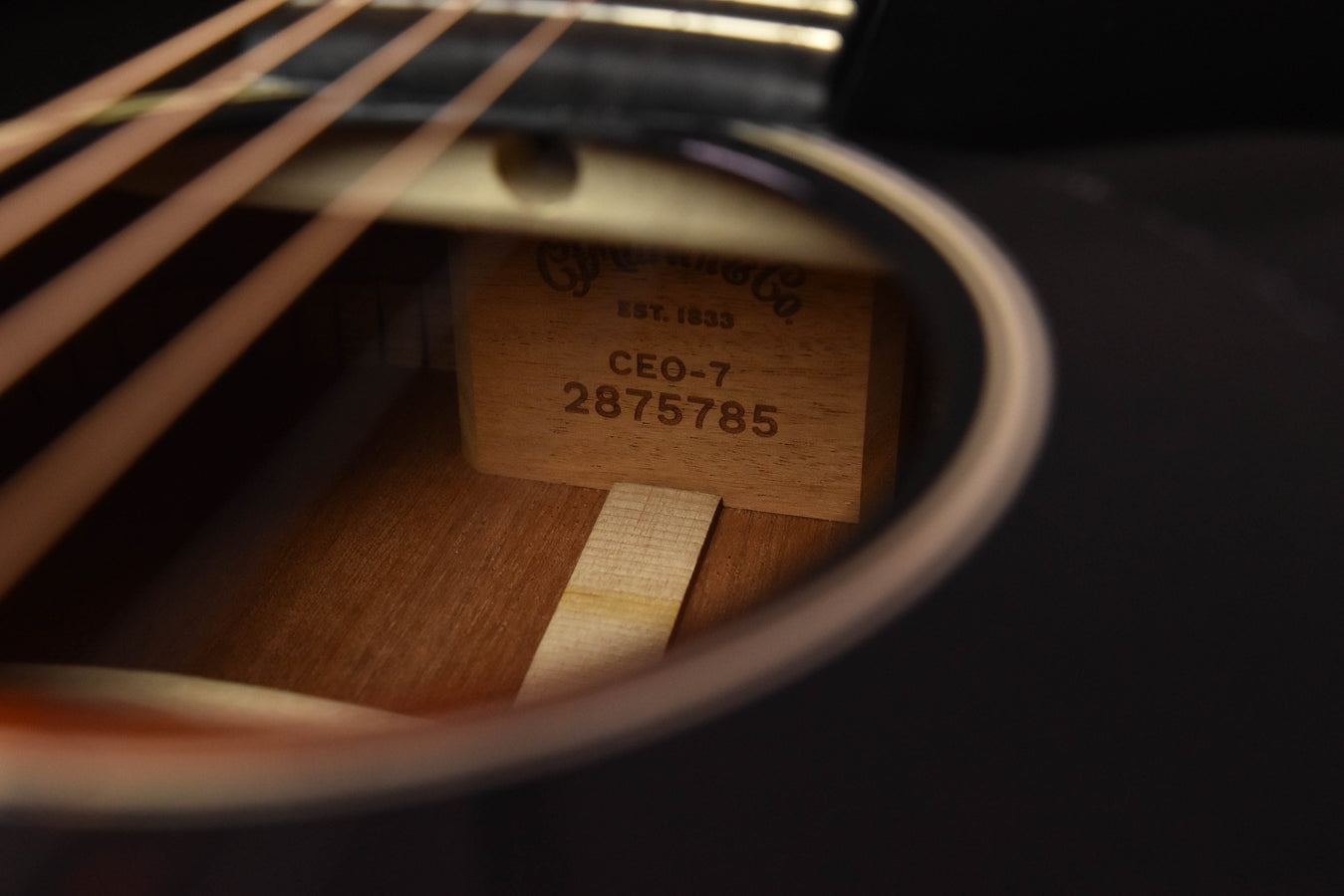 Inside guitar close-up of CEO-7 serial number on wood label