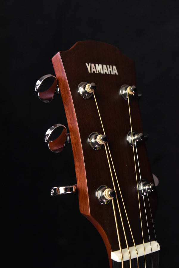 Yamaha acoustic-electric guitar headstock with tuning pegs and logo