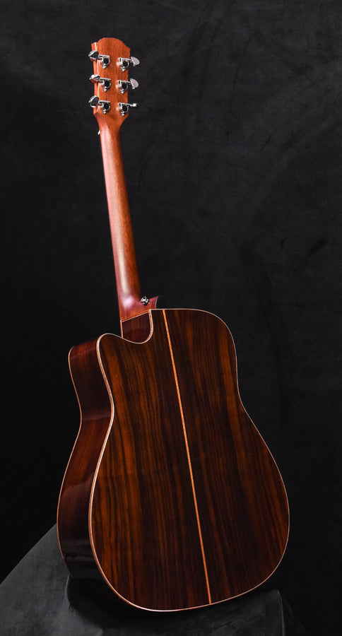 Acoustic-electric guitar headstock and neck with tuning pegs, dark wood finish