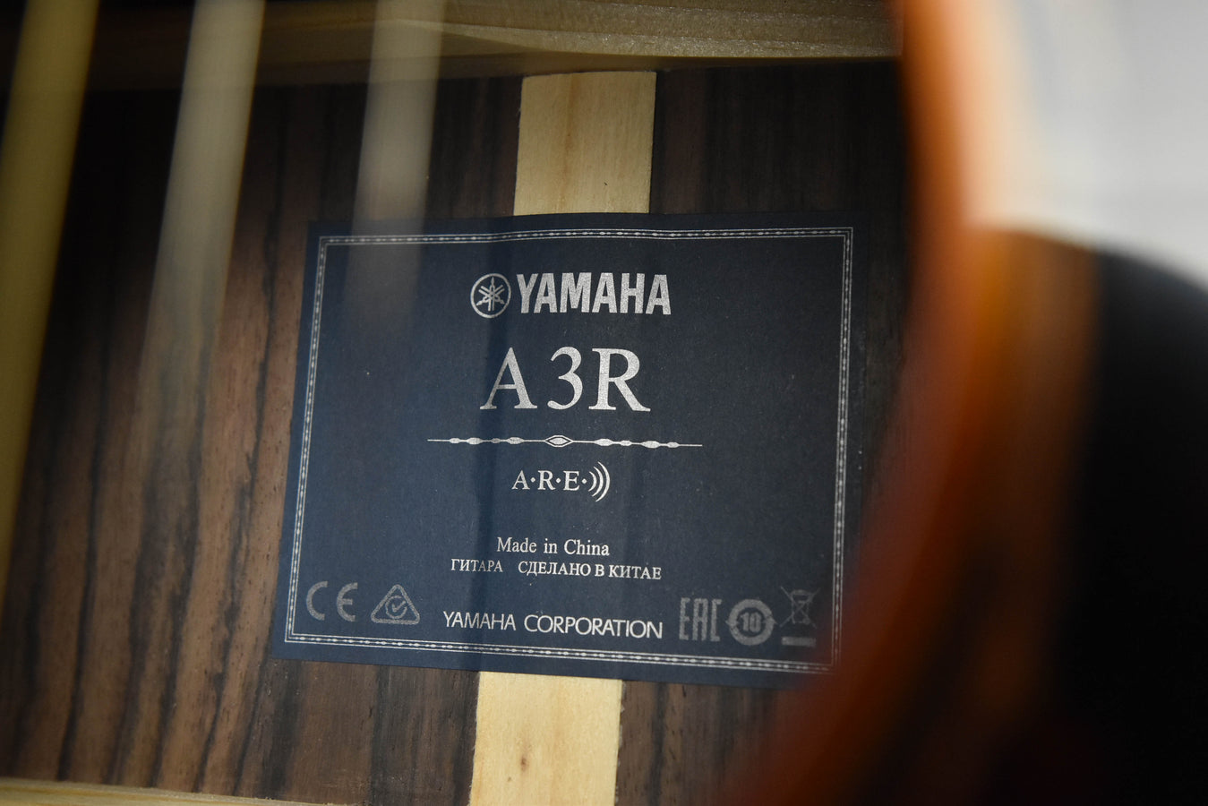 Yamaha A3R A·R·E label on guitar soundboard, Made in China text visible